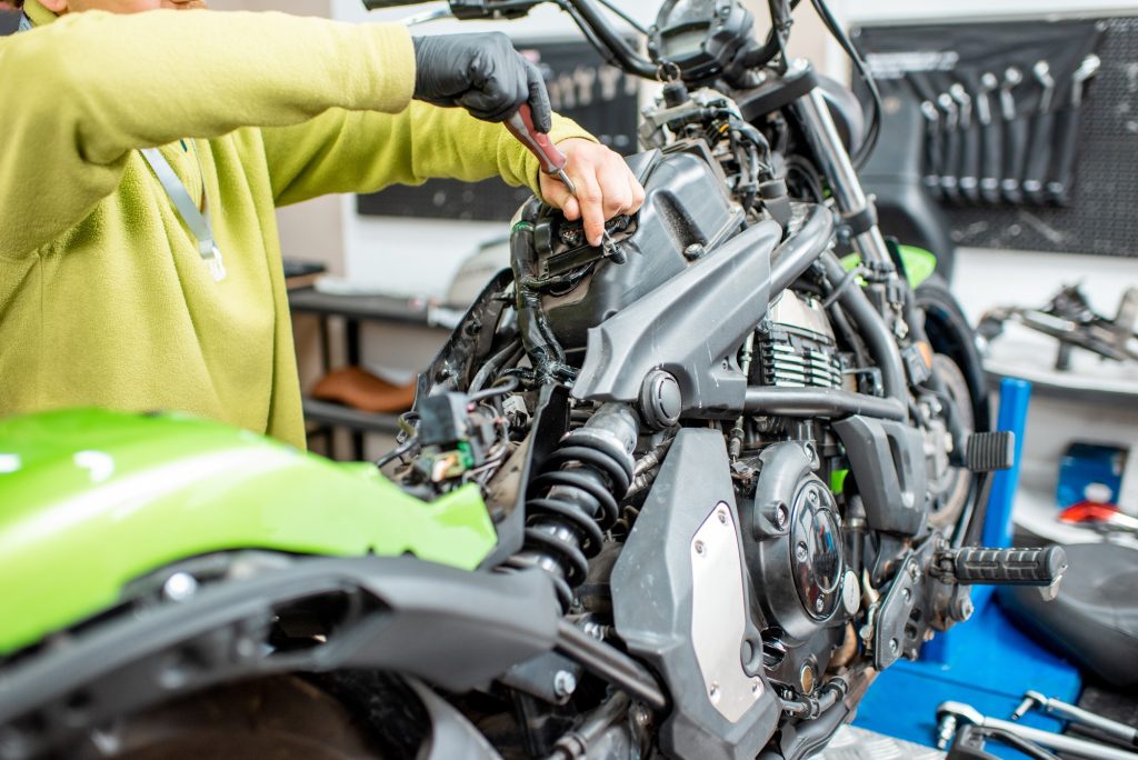 Electrician repairing motorcycle wiring